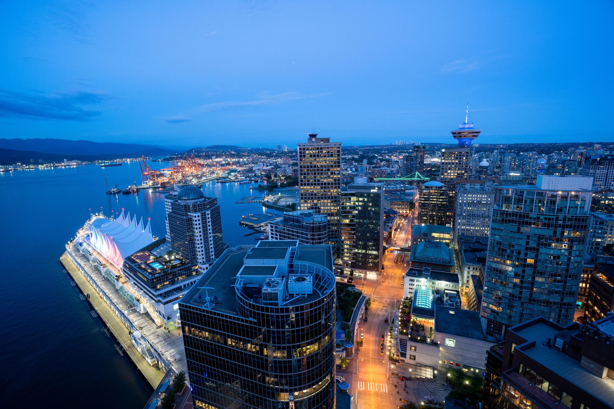 Downtown Vancouver Skyline at Twilight A stunning aerial view of downtown Vancouver at dusk, featuring illuminated skyscrapers