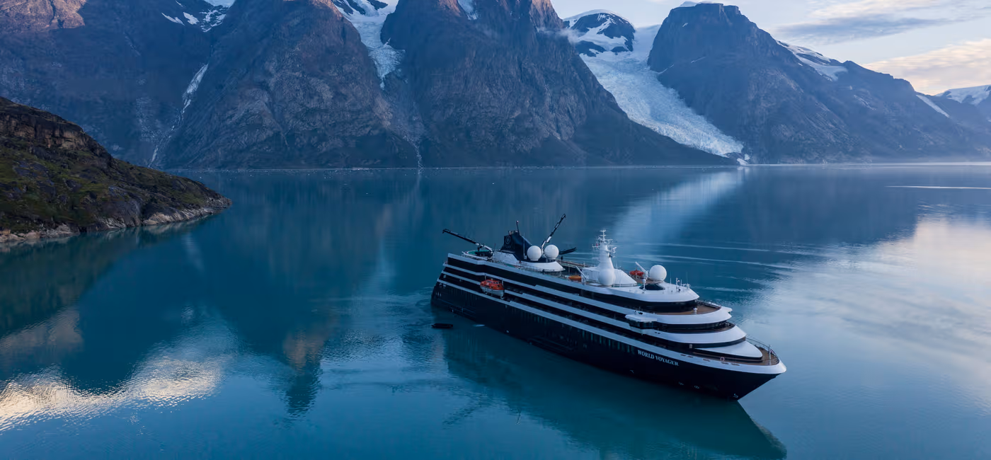 Image-Aerial-of-World-Voyager-in-Greenland-Photo-C Viking Octantis expedition ship navigating pristine Antarctic waters among massive icebergs