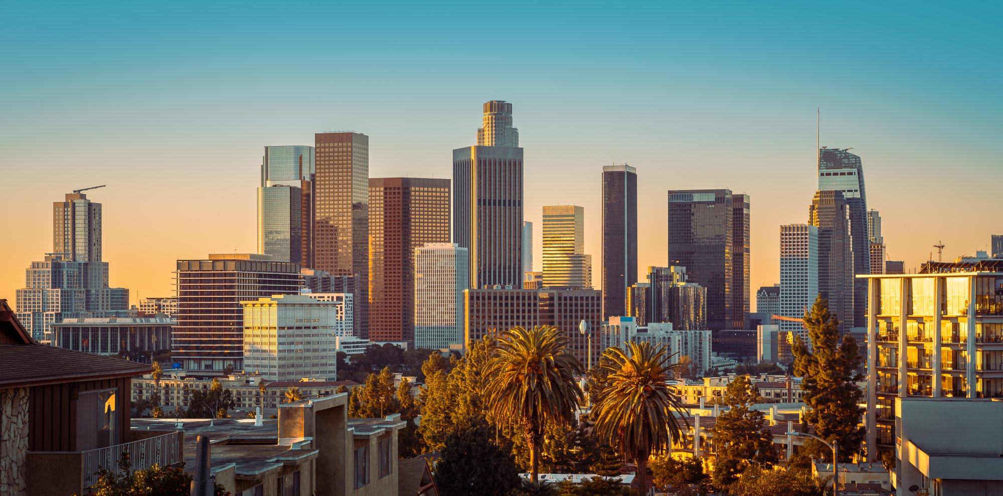 Los Angeles Skyline at Golden Hour A stunning view of downtown Los Angeles skyline bathed in warm golden sunlight during sunset